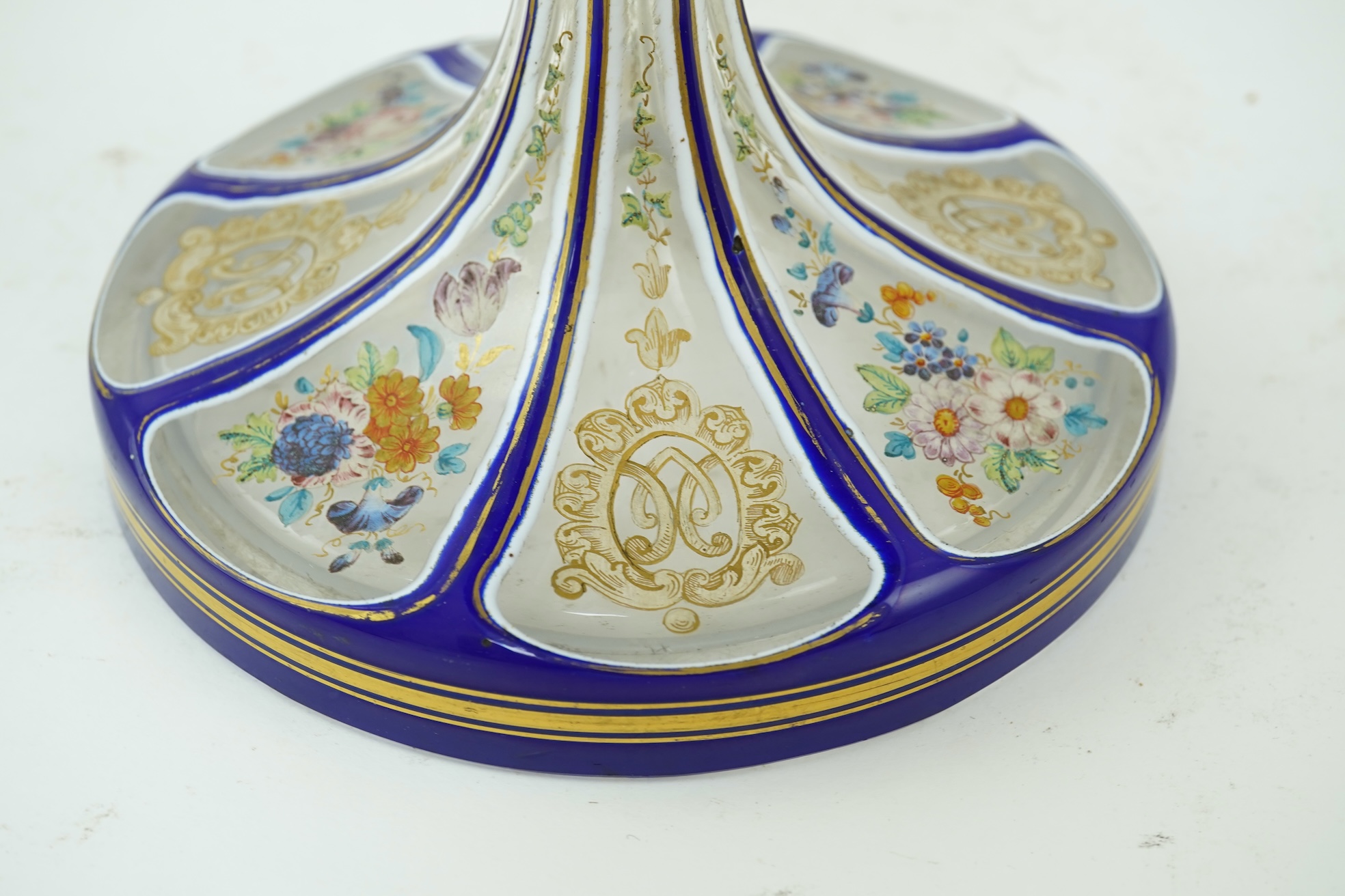 A tall 19th century Bohemian blue and white overlaid gilt and enamel decorated vase in the manner of Moser